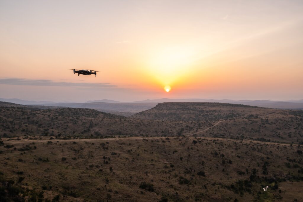 A drone flying over the hills with the beautiful sunset in the background in Kenya, Nairobi, Samburu